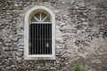 White window in old grey stone wall. Old medieval architecture. Royalty Free Stock Photo