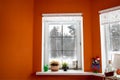 White window in orange room from which the view of the winter forest. Window to snow forest. The windows were frozen and covered Royalty Free Stock Photo
