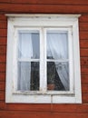 A white window of a red wooden house Royalty Free Stock Photo