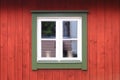 White window in a red wooden wall