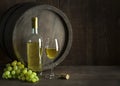 White wine bottle and glass with barrel background Royalty Free Stock Photo