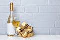 White wine bottle with empty label, glass for tasting and gift box for romantic surprise Royalty Free Stock Photo