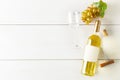 White wine bottle with grapes, corkscrew, cork and wine glass on white wooden table flat lay from above Royalty Free Stock Photo