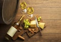 White wine bottle and glass with barrel background Royalty Free Stock Photo