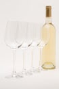 White wine bottle with wineglasses lined up