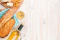 White wine, cheese and bread on white wooden table background Royalty Free Stock Photo