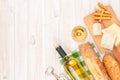 White wine, cheese and bread on white wooden table background Royalty Free Stock Photo