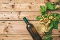 White wine glass and bottle and fresh grapes on wooden background, copy space Royalty Free Stock Photo