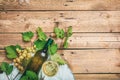 White wine glass and bottle and fresh grapes on wooden background, copy space Royalty Free Stock Photo