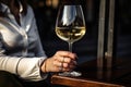 Female hand holds one glass goblet with white wine. Royalty Free Stock Photo