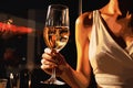 Female hand holds one glass goblet with white wine. Royalty Free Stock Photo