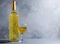 White wine in glass wine glasses, a bottle of wine. Blue background. Copy space Royalty Free Stock Photo