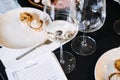White wine glasses and gourmet bites set beside tasting notes during a wine education session. Emphasizes rustic Royalty Free Stock Photo