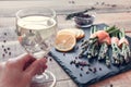 White wine in hand and bunches of asparagus wrapped in salmon Royalty Free Stock Photo