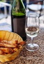 White wine Pinot Noir in glass with bread sticks in basket