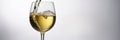 White wine pouring into a glass on a white background Royalty Free Stock Photo