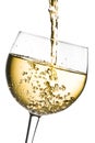 White wine pouring into glass tilted with space for text Royalty Free Stock Photo