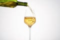 White wine pouring from green bottle, close up. Royalty Free Stock Photo