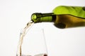 White wine pouring from green bottle, close up. Royalty Free Stock Photo