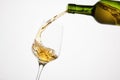 White wine pouring from green bottle, close up shot on white isolated. Royalty Free Stock Photo