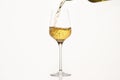 White wine pouring from green bottle on white isolated, close up. Royalty Free Stock Photo