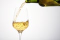 White wine pouring from green bottle, close up. Royalty Free Stock Photo