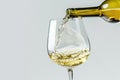 white wine pours from a bottle into a glas Isolated on white background Royalty Free Stock Photo