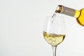 white wine pours from a bottle into a glas Isolated on white background Royalty Free Stock Photo