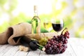 White wine and red wine in a glass with fall grapes, white wooden background Royalty Free Stock Photo