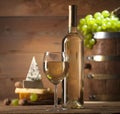 White wine with various types of cheese on wooden background Royalty Free Stock Photo