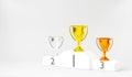 White winner podium, gold, silver and bronze trophy cup on prize podium for the champions Royalty Free Stock Photo