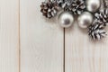 White winter cones on the wooden table with silver balls.Christmas background Royalty Free Stock Photo