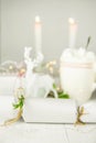 White Winter Decoration in Scandinavian Style. Wrapped Gift Boxes Twine Juniper Twigs. Lit Candles Deer Bokeh Garland Lights Royalty Free Stock Photo