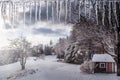 The white winter wonderland scenery in Londonderry, Vermont with snow covered trees, icicles and blue cloudy sky in the background Royalty Free Stock Photo