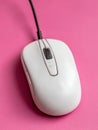 White wired computer mouse on a pink background. Royalty Free Stock Photo