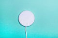 White wireless charging pad for smartphone on the green background. Royalty Free Stock Photo