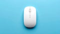 Overhead view of a white wireless computer mouse with scroll wheel on a blue background Royalty Free Stock Photo