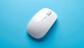 Top view of a white wireless computer mouse with scroll wheel on a blue surface wireless mouse Royalty Free Stock Photo