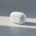 White wireless earbuds case on a reflective surface Royalty Free Stock Photo