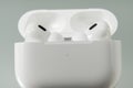 White wireless earbuds resting in an open charging case, photographed close up. Royalty Free Stock Photo