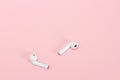 White Wireless headphones on pink background