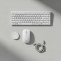 White wireless keyboard, mouse, charging cable, and a circular Royalty Free Stock Photo