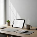 A white wireless mouse and mouse pad are neatly placed in front of the tablet Royalty Free Stock Photo