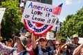 A Woman Holds a Sign Reading `America Love it Or Leave it` at a Conservative Rally Royalty Free Stock Photo