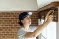 White woman installing window curtain Royalty Free Stock Photo