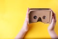 White woman`s hands holding cardboard virtual reality glasses Royalty Free Stock Photo