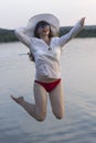 White woman in sun hat jump in water Royalty Free Stock Photo