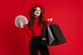 White woman in sunglasses posing with shopping bags and dollars Royalty Free Stock Photo