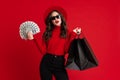 White woman in sunglasses posing with shopping bags and dollars Royalty Free Stock Photo