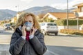 White woman walks the street with the protective mask in the times of the coronavirus `Covid-19` which is affecting many people